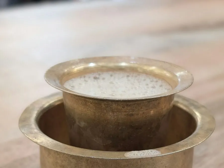 Filter coffee in a brass tumbler and davara