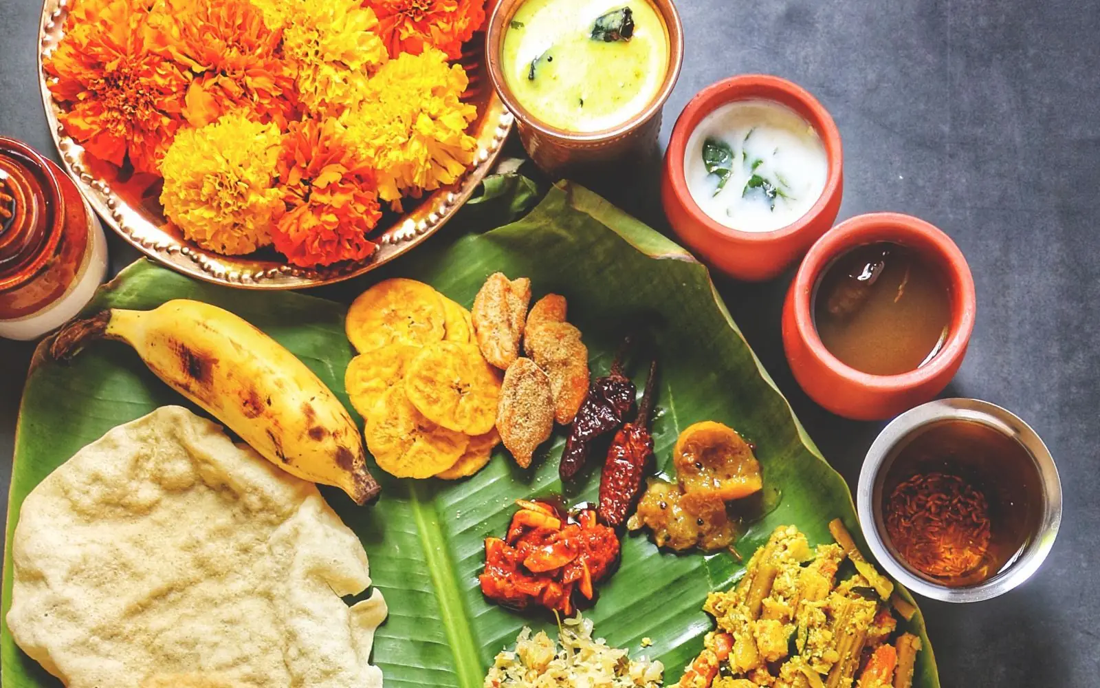 Sadya meal served on a banana leaf, with rice, curries and payasam